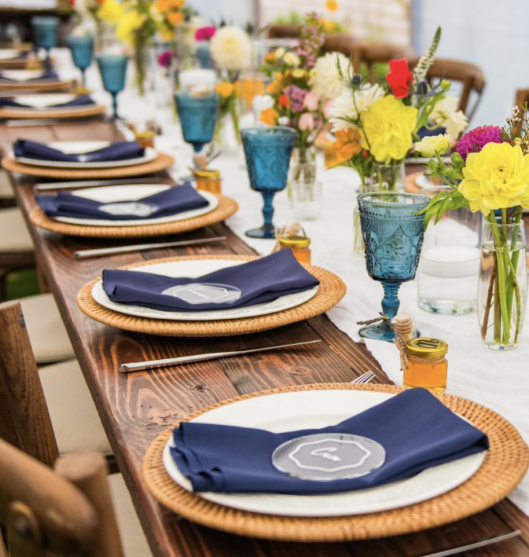Place settings with chargers, napkins and glassware