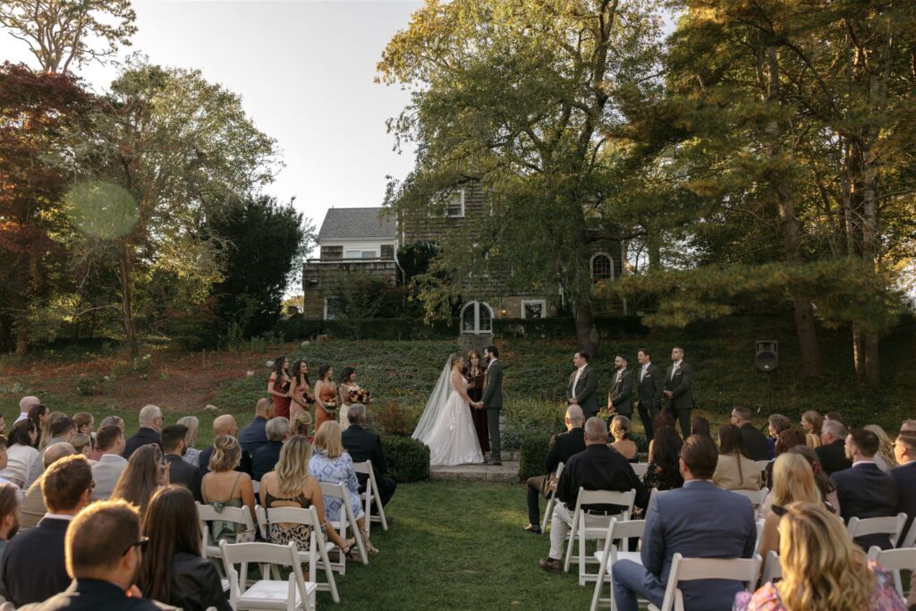 Outdoor wedding ceremony with white folding chairs