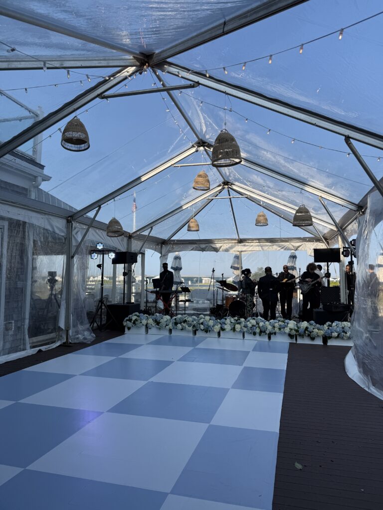 Clear-top tent with a live band and checkered dance floor